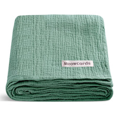 Meowcards muslin swaddle: closeup of soft double muslin for gentle baby comfort.