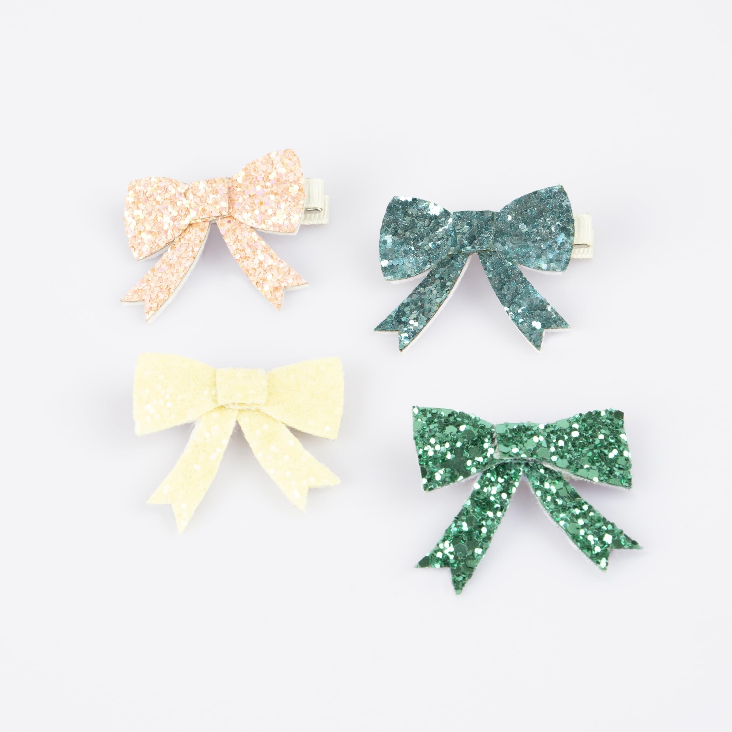 Meri Meri glitter bow clip 4-pack in four colors for instant party-ready style.
