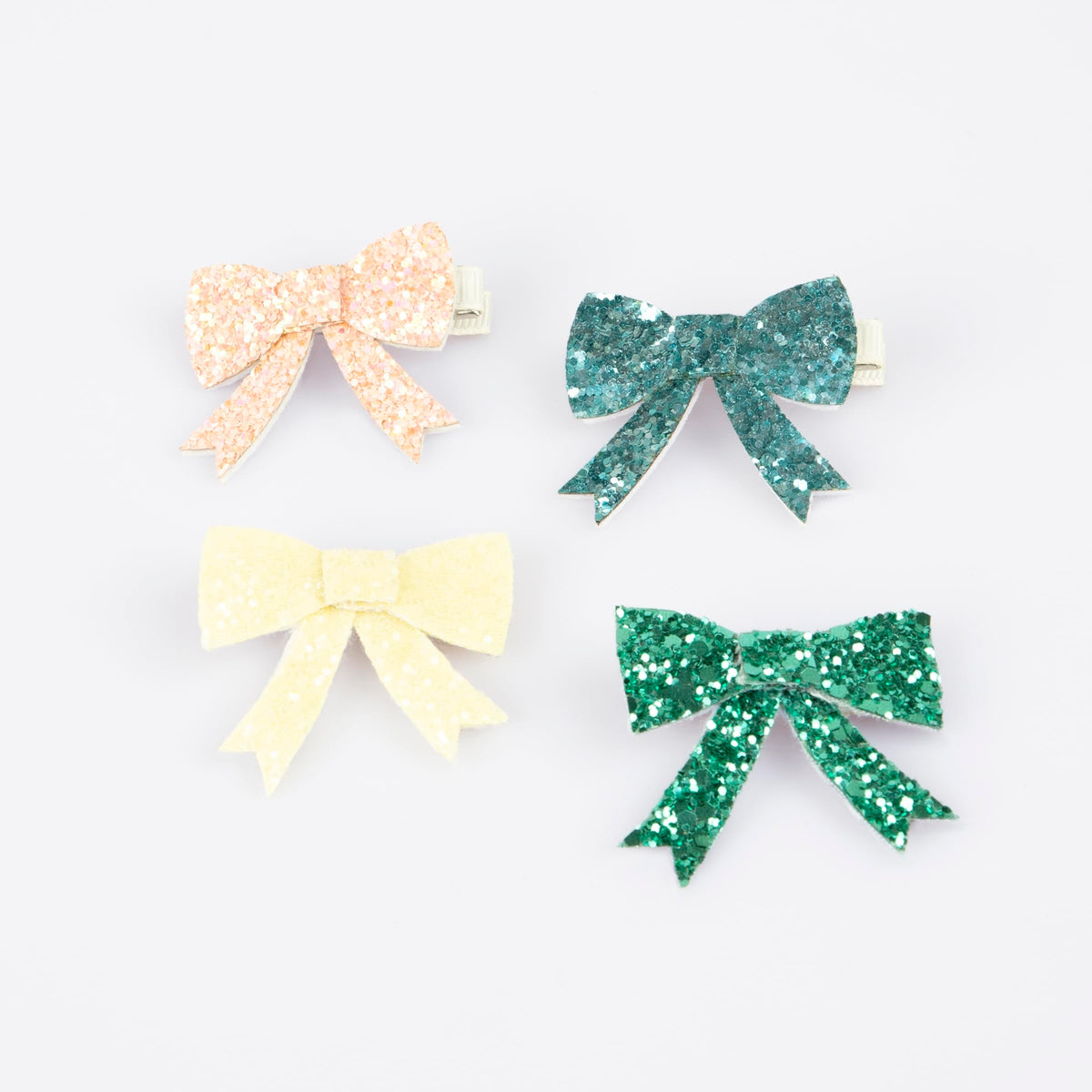 Meri Meri glitter bow clip 4-pack in four colors for instant party-ready style.