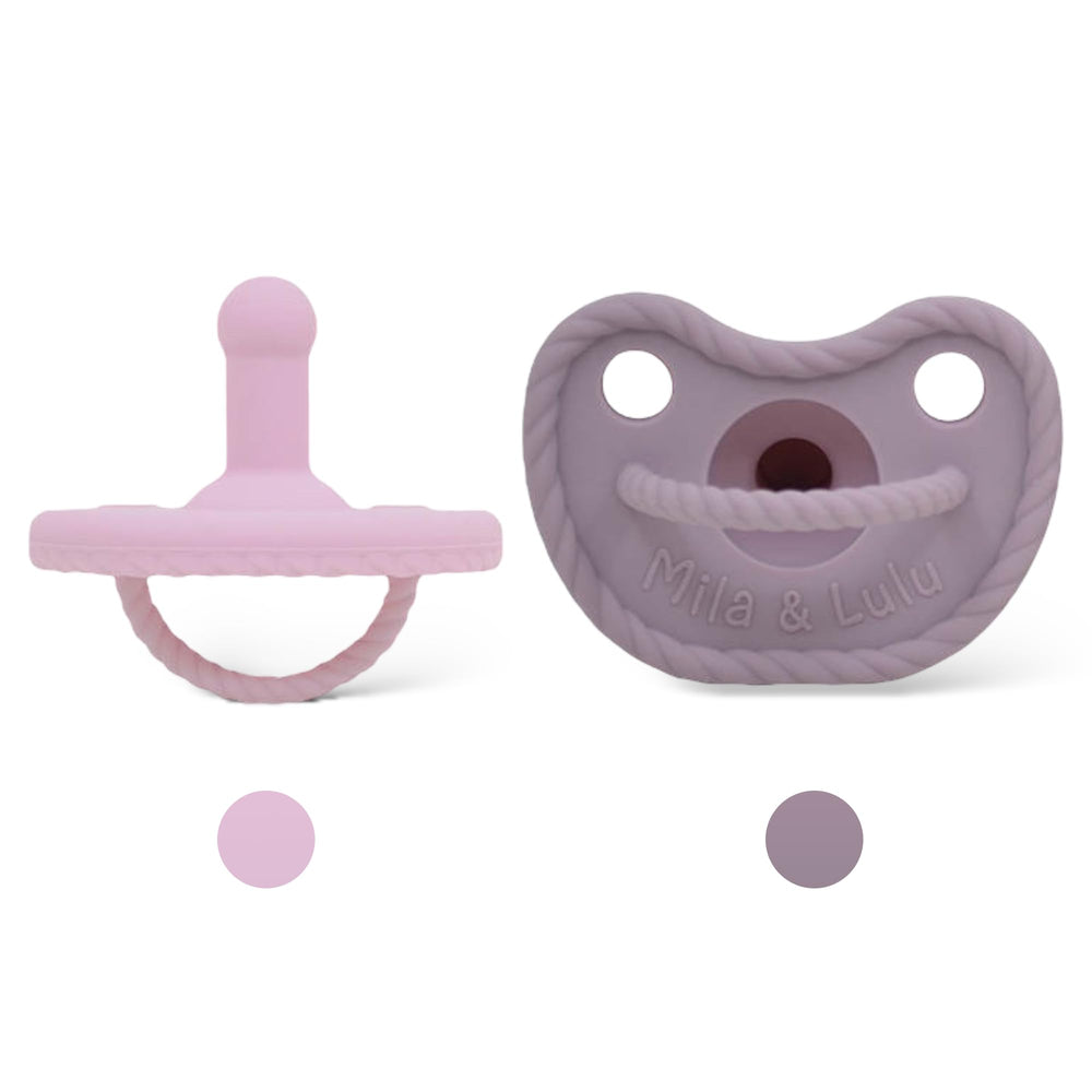 Mila & Lulu round silicone pacifier closeup highlights soft nipple for soothing newborn comfort.