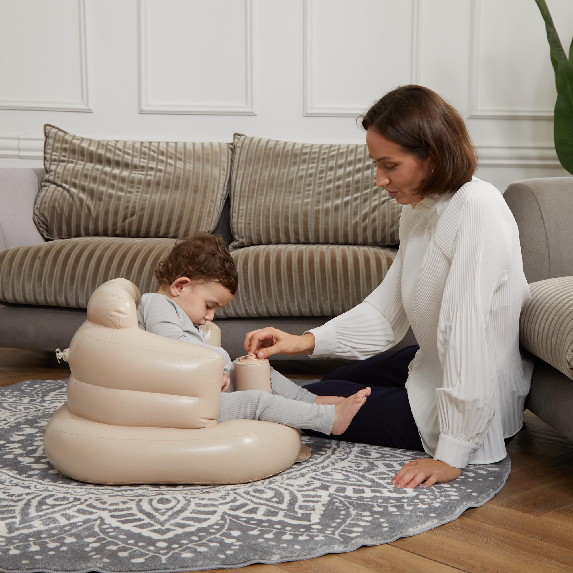 Mink inflatable baby seat khaki folded for compact storage and travel.