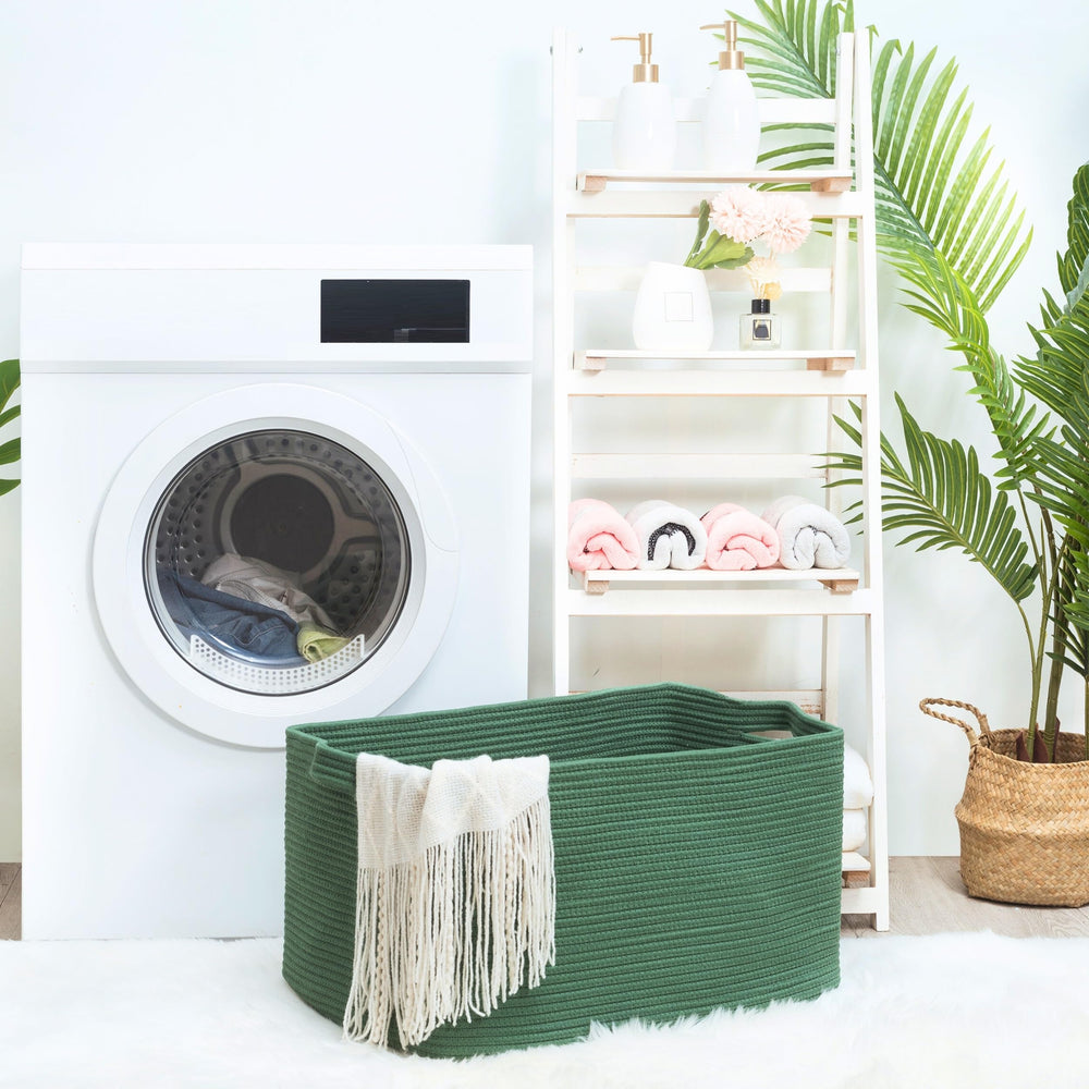 Mintwood Design dog toy storage bin forest green beside sofa