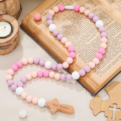 Misdary baby rosary pastel purple beads close-up, a gentle baptism keepsake idea