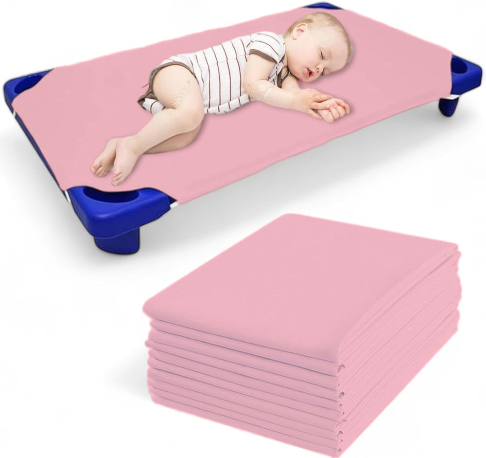 Mississippi Cotton pink cot sheets folded, showing soft, durable polyblend fabric for daycare.