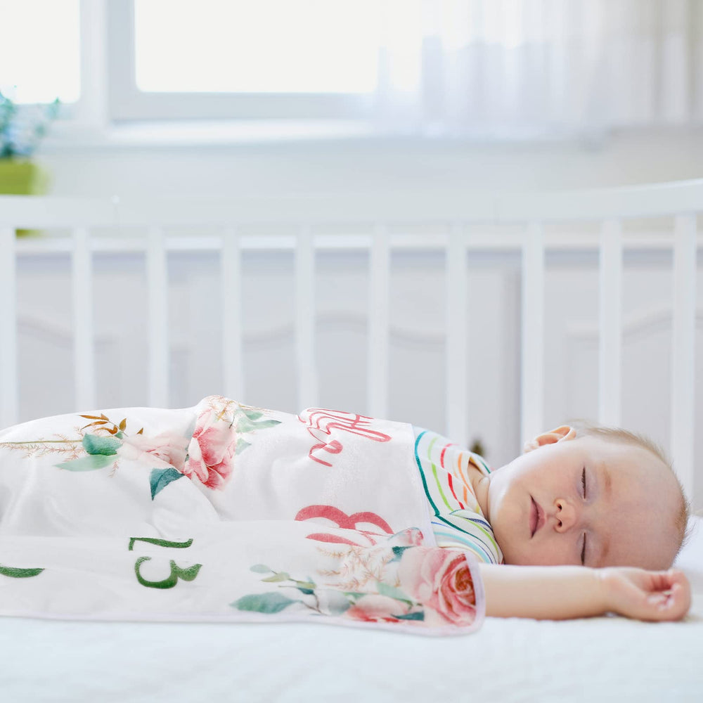 Mixweer milestone blanket used as stroller padding or crib backdrop in shoots.