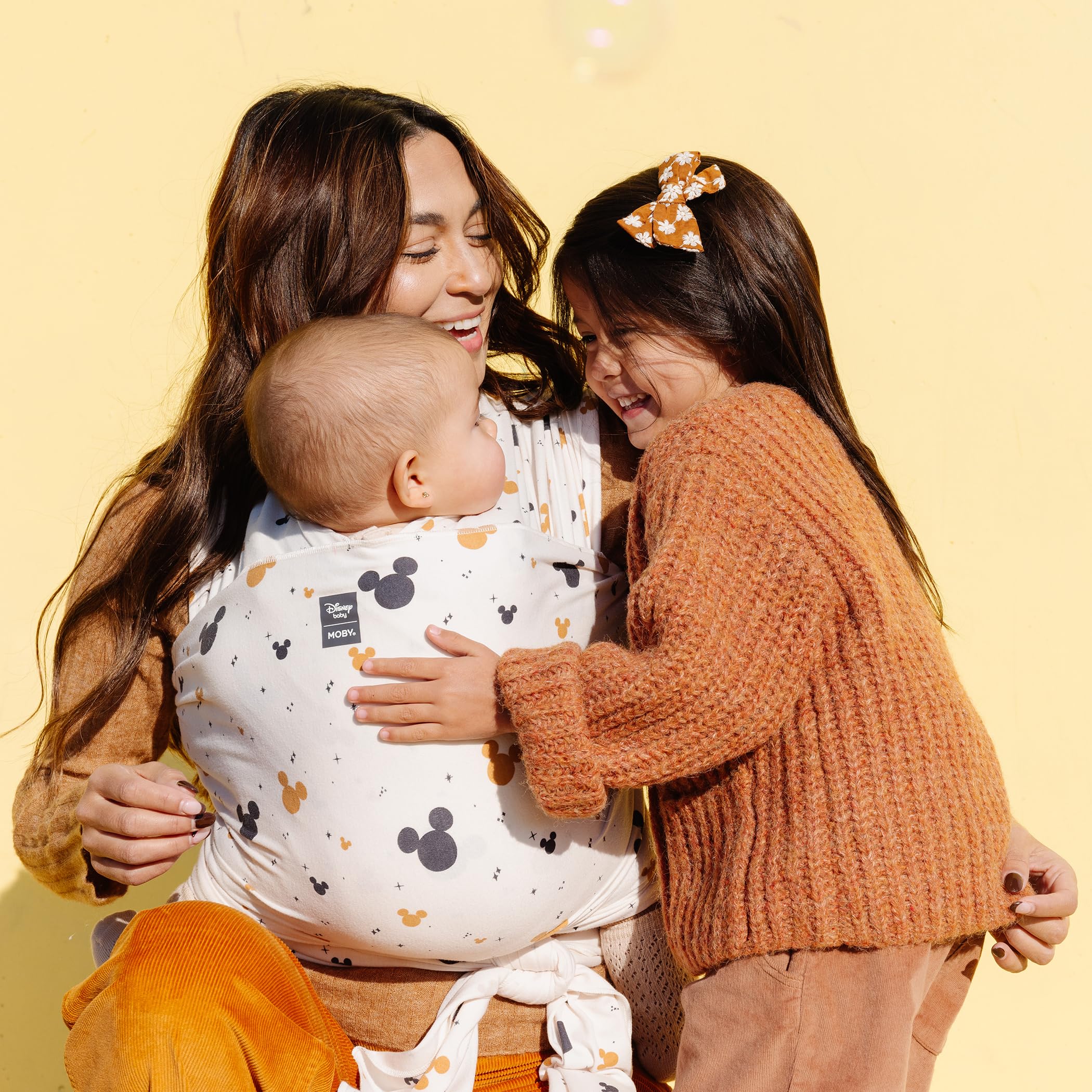 Moby Featherknit wrap back carry displays ergonomic support for longer wear.