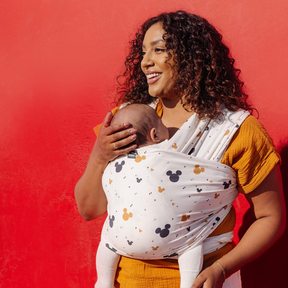 Moby Featherknit wrap front carry demonstrates strolling comfort and close contact.