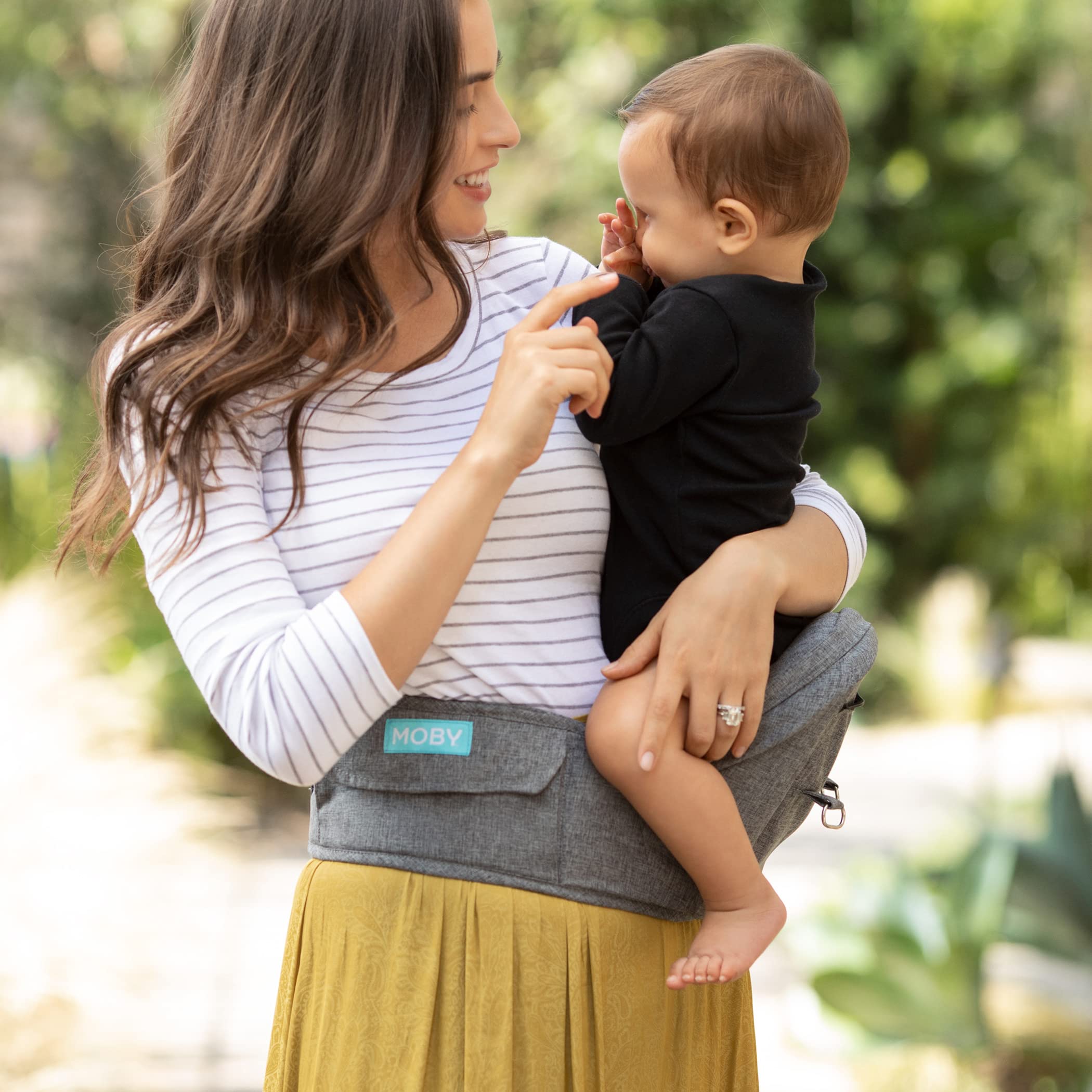 Moby hip seat in grey enables easy transitions as baby moves.