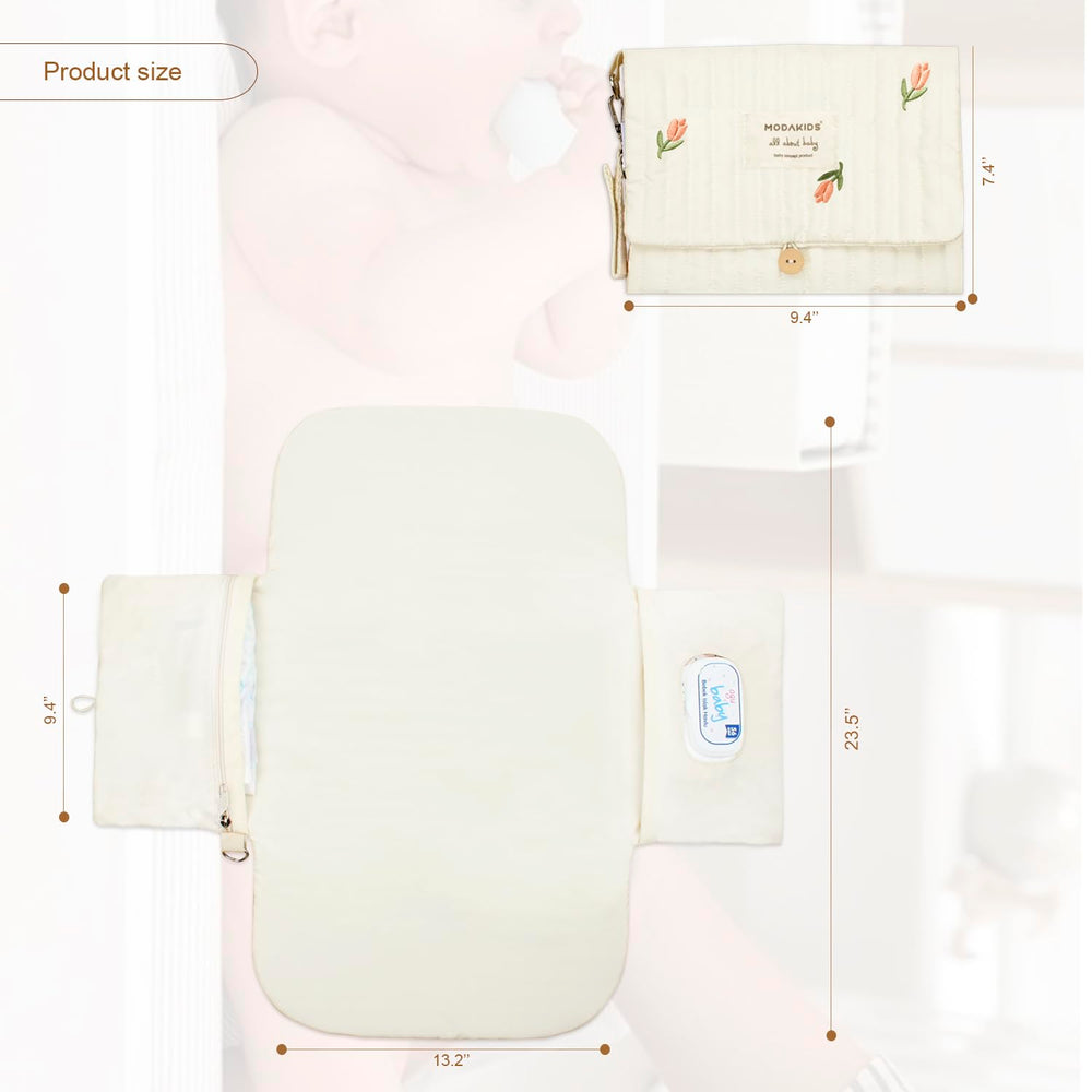 MODAKIDS portable diaper changing pad open showing soft cushioned surface.