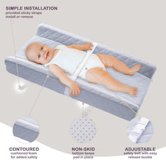 Modera changing pad safety strap closeup demonstrates secure newborn positioning during changes.