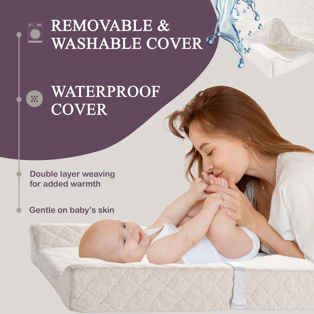 Modera changing pad features adjustable safety strap for secure newborn diapering