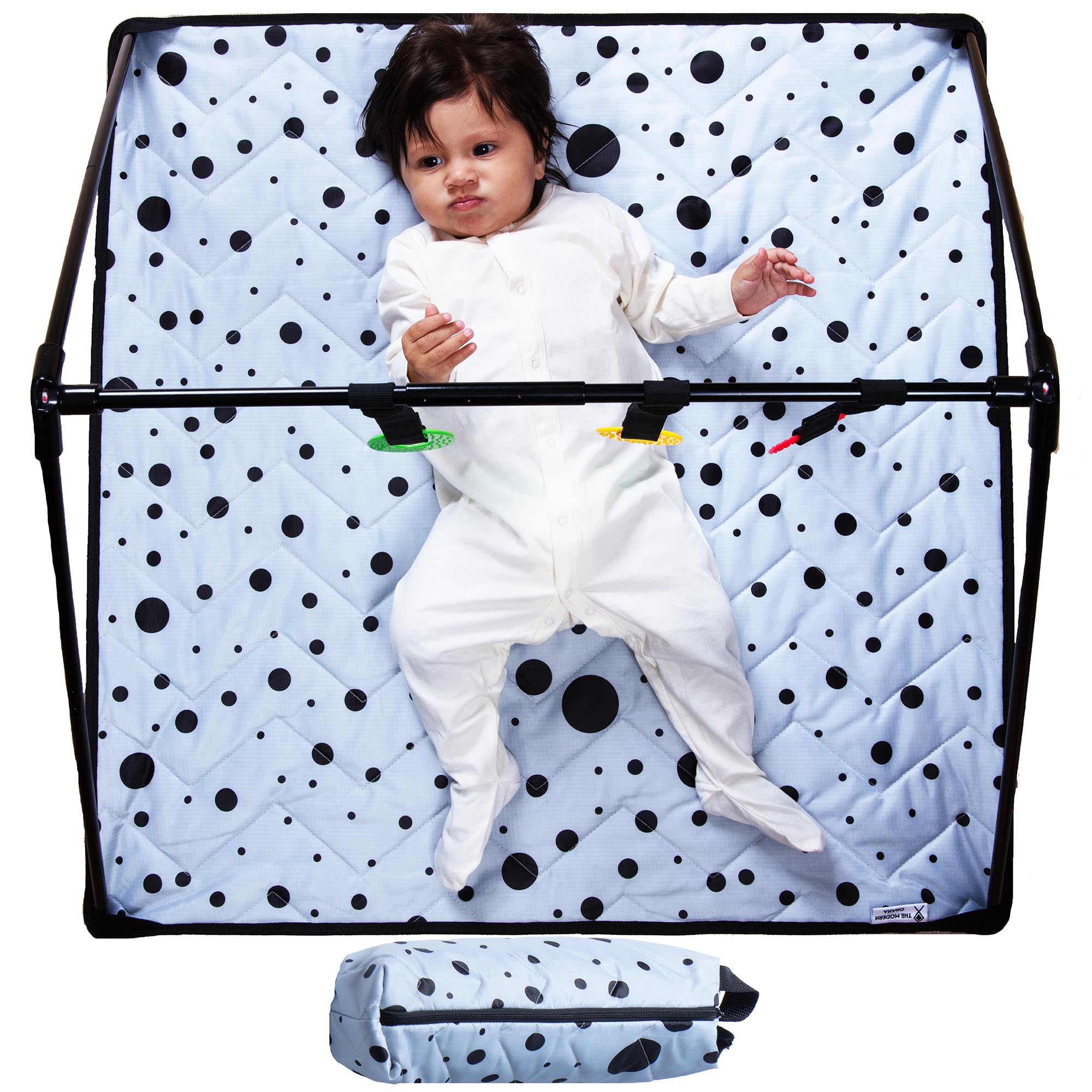 The Modern Ohana travel baby play mat folding in action for quick setup.