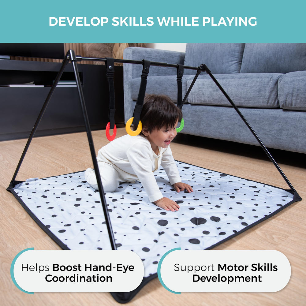 The Modern Ohana travel baby play mat in tummy-time position on the floor.