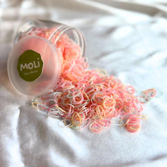 MoLi Baby Collection soft gel elastics closeup showing gentle hold on thin hair.