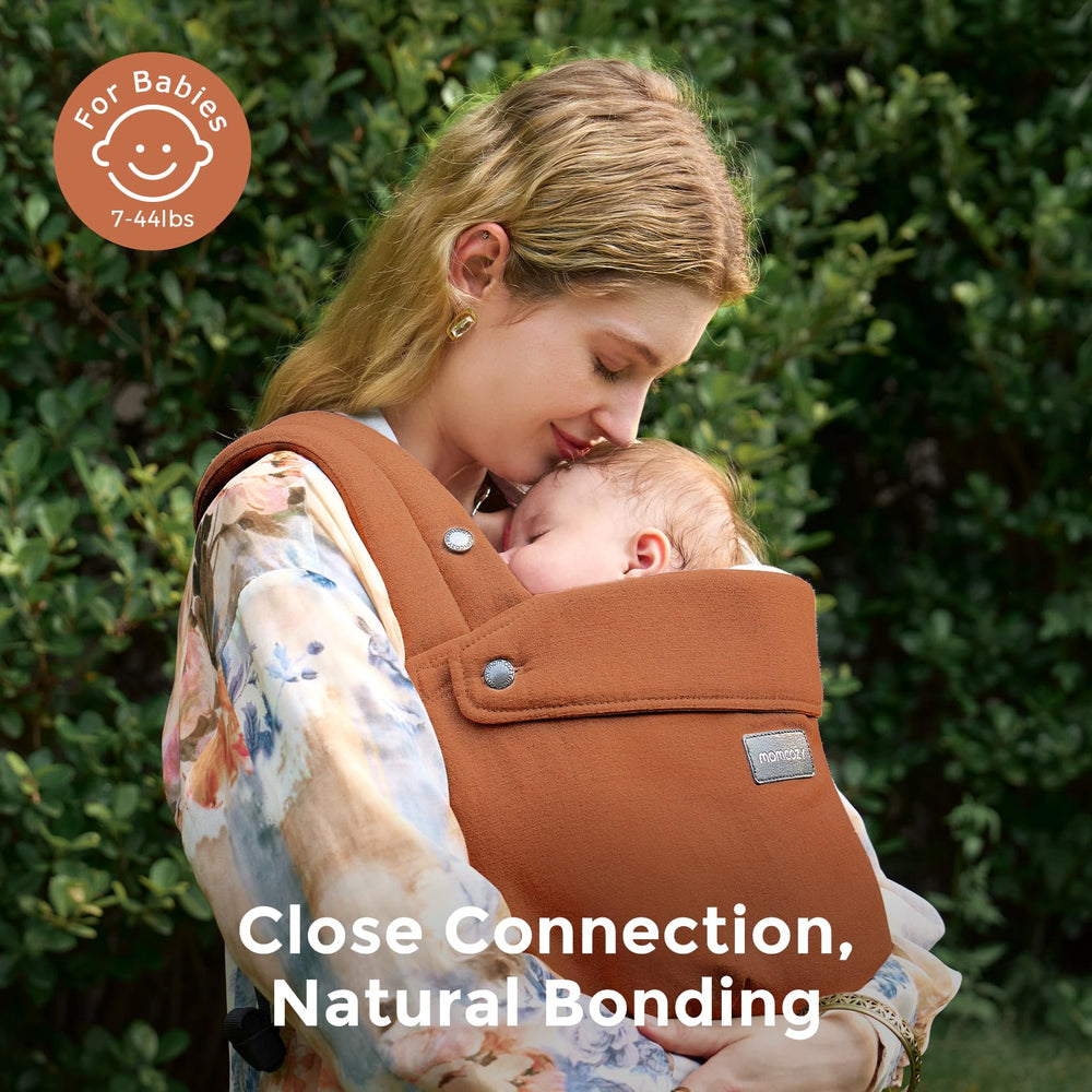 Momcozy baby carrier demonstrates ergonomic M-position for hip-friendly seating.