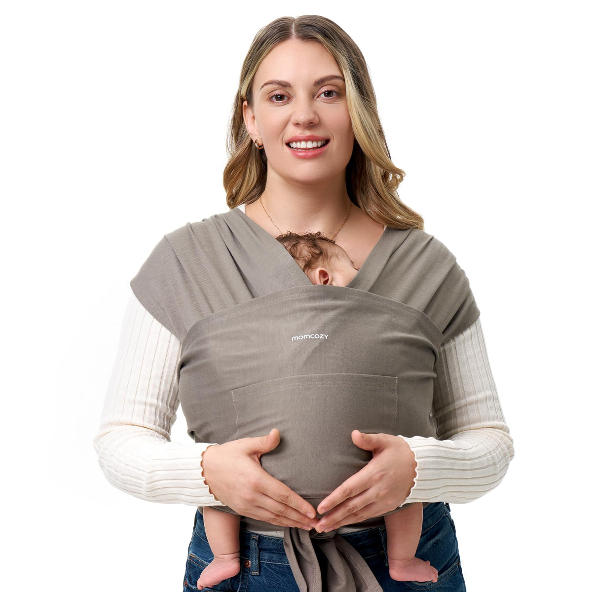 Momcozy baby wrap in brown worn by parent, enabling hands-free mobility with a snug fit.