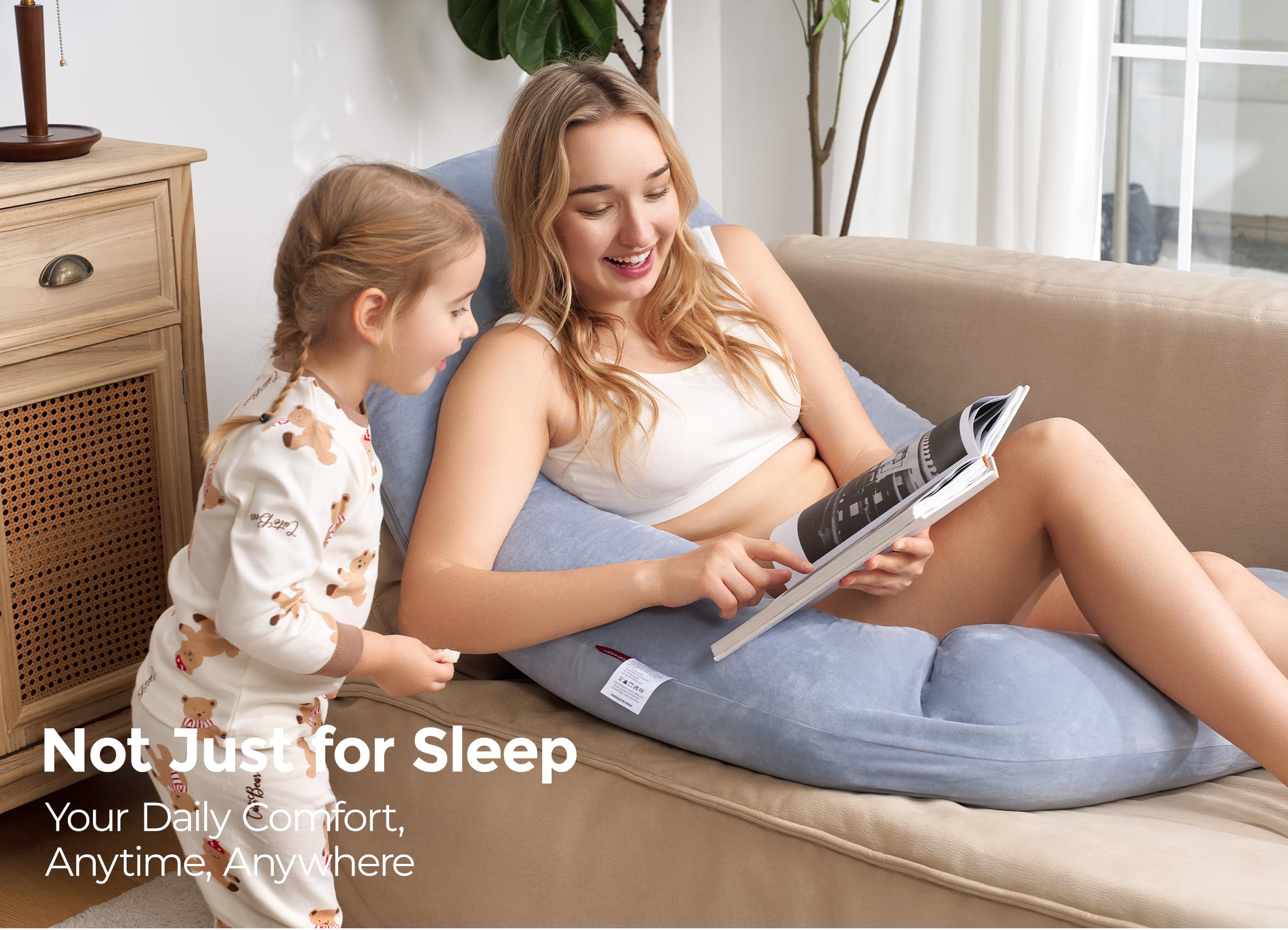 Momcozy Dreamlign U Pro in-use shot suggests multi-position comfort for reading.