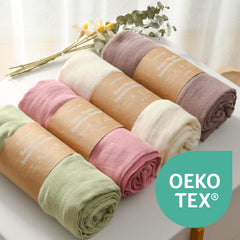 Momcozy Muslin Swaddle Blanket light green folded, neutral style.