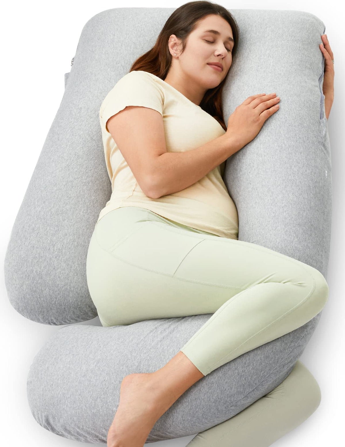 Momcozy U shaped pregnancy pillow on bed provides full body support for comfort.