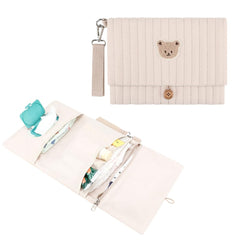 MOMIGO Love Bear embroidered diaper bag on cream quilted fabric, ideal for organized on-the-go outings.