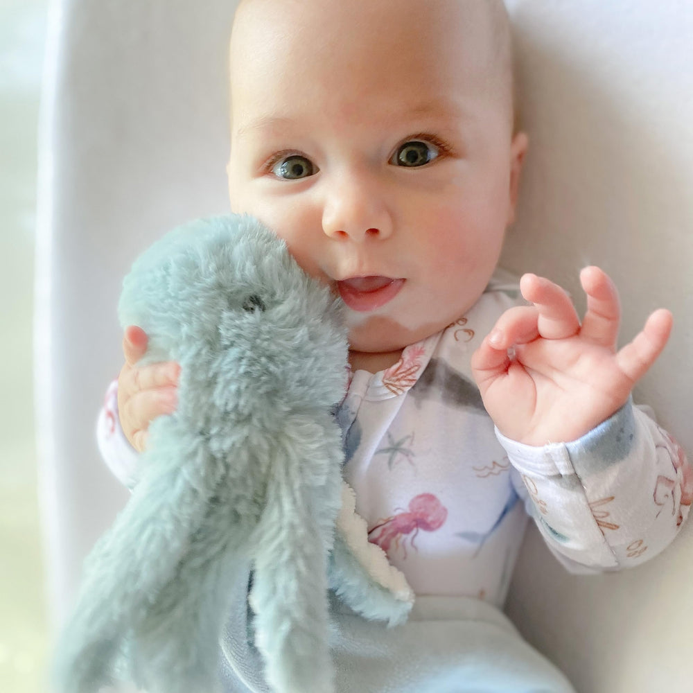 MON AMI Oda octopus plush lovey’s knotted edges promote sensory play and calm moments.
