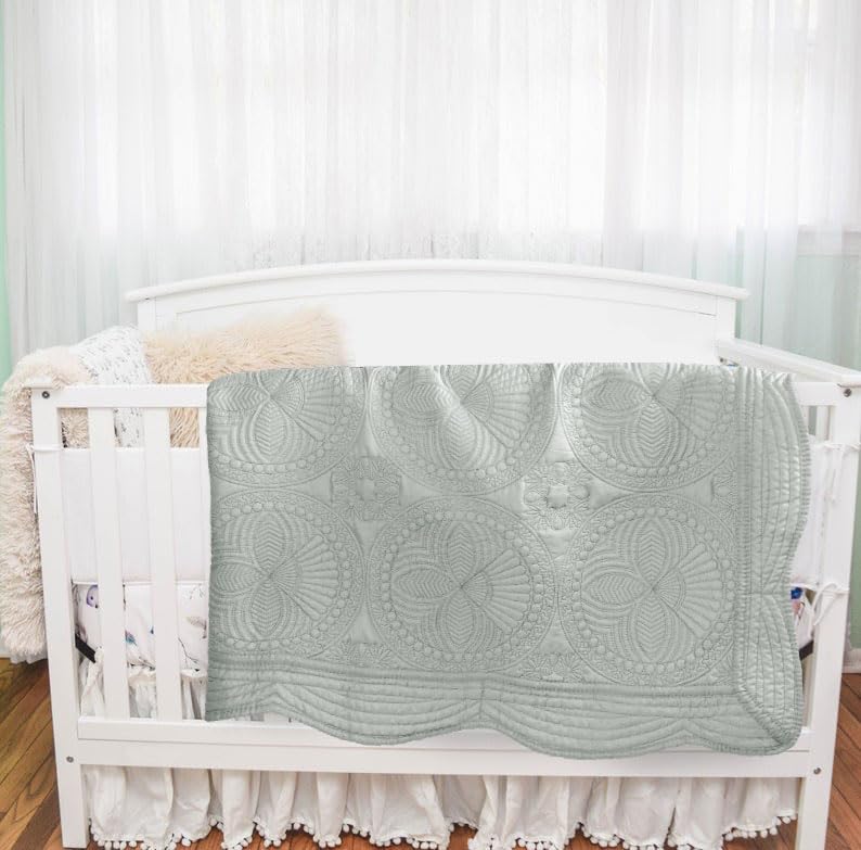 MONOBLANKS heirloom-gray-quilt-scalloped-edge adds decorative softness to any nursery.