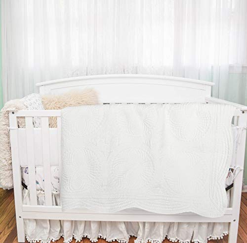 MONOBLANKS baby quilt on a toddler bed used as a cozy blanket