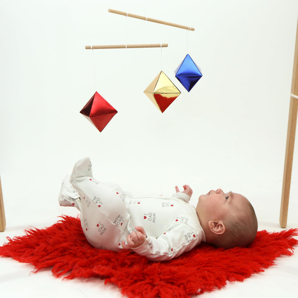 Montessori baby mobile set hanging from crib simplifies nursery decor