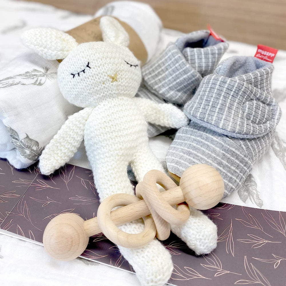 Moody Park baby gift basket booties highlight plush toes and vegan leather soles for warm newborn strolls.