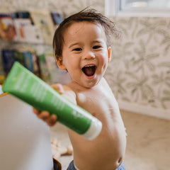 MooGoo Baby moisturizer applied to arm shows lightweight hydration for irritated skin.