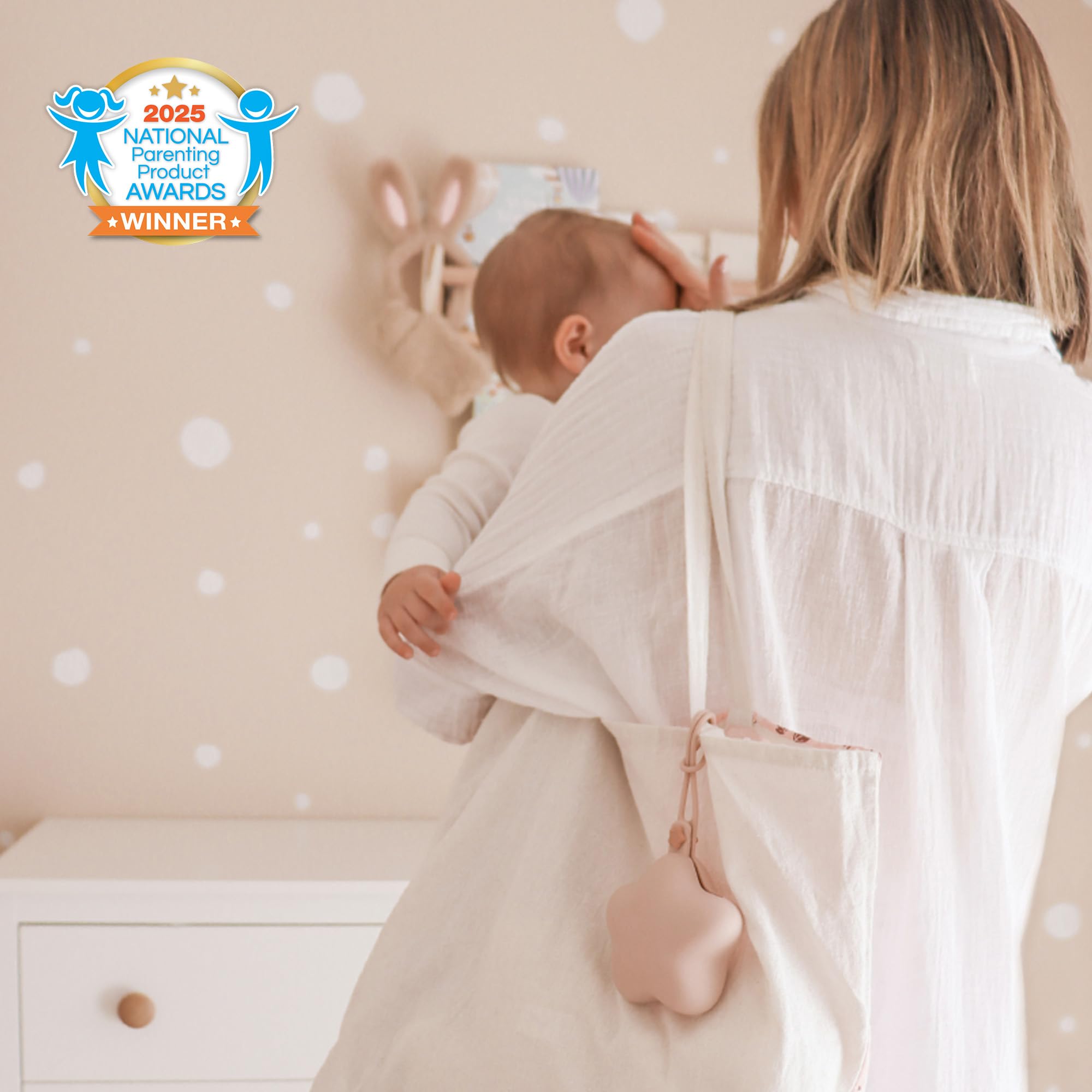 Moonkie pacifier case attached to diaper bag shows hands-free convenience