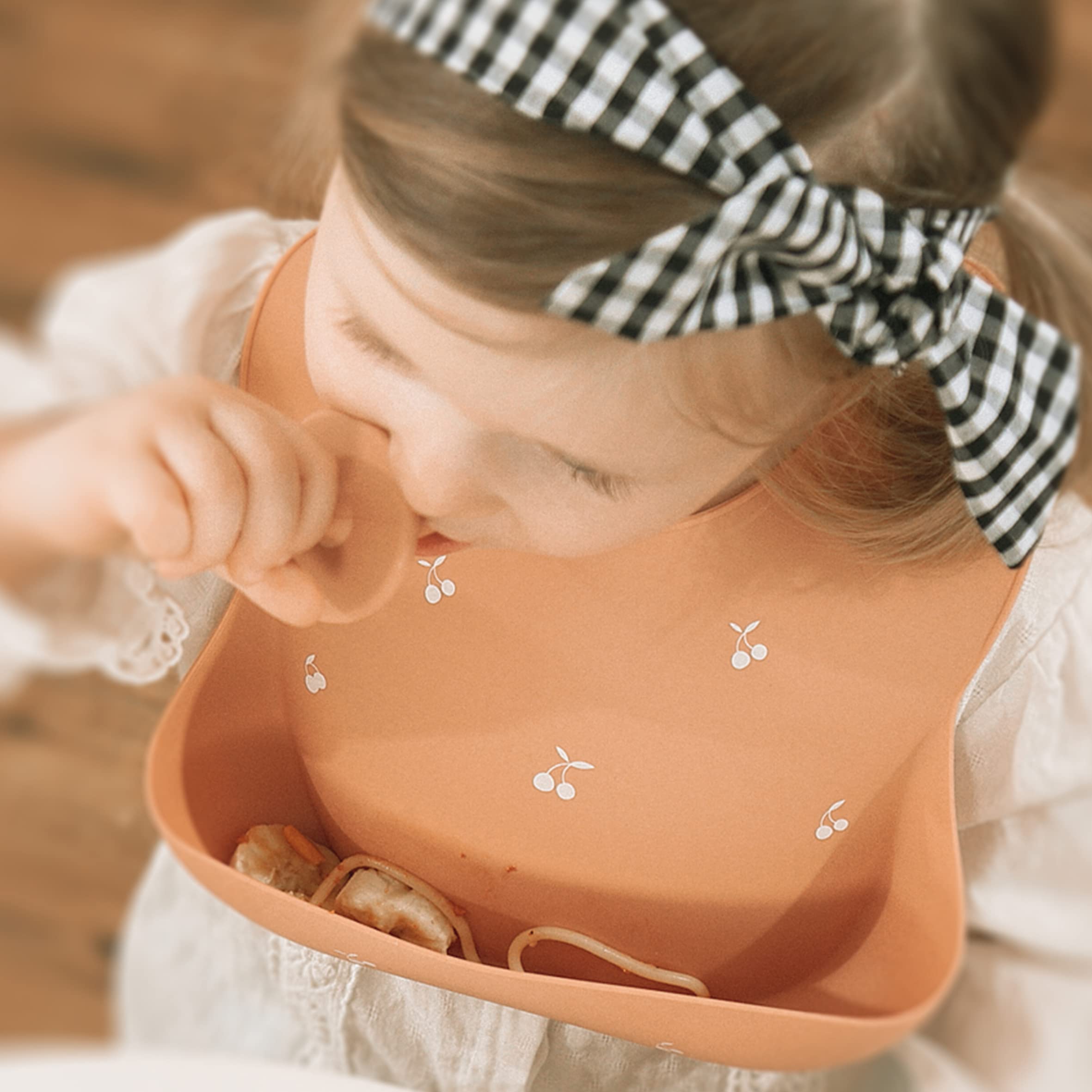 Moonkie dishwasher-safe bib — easy cleanup under running water.