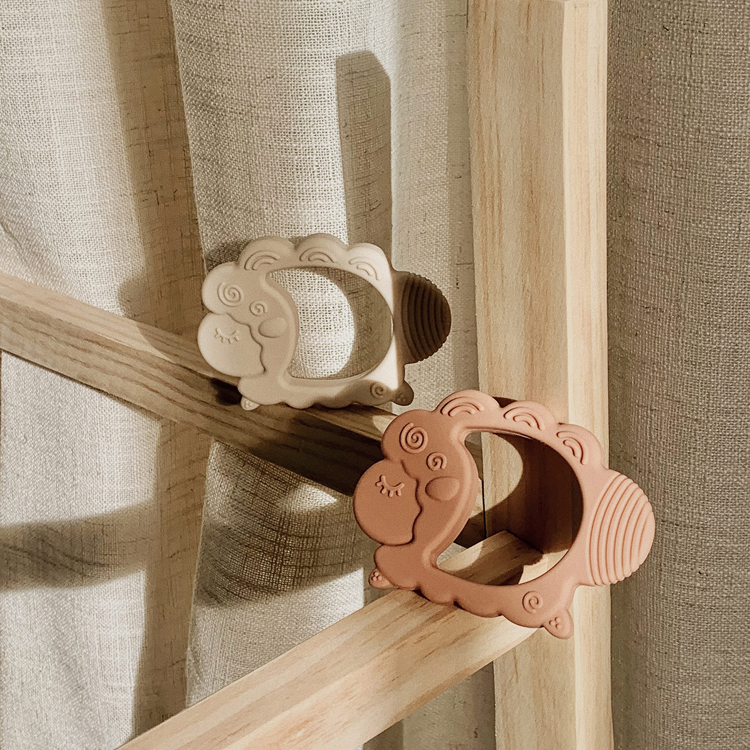 Moonkie newborn-friendly teether supports grasp development with wide opening.
