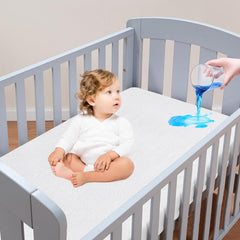 Moonsea crib mattress protector showing waterproof top layer for spill protection during naps