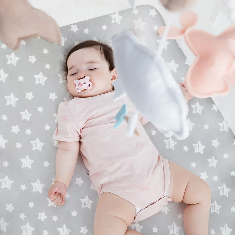 Moonsea crib sheets in gray and navy patterns add cozy nursery styling.