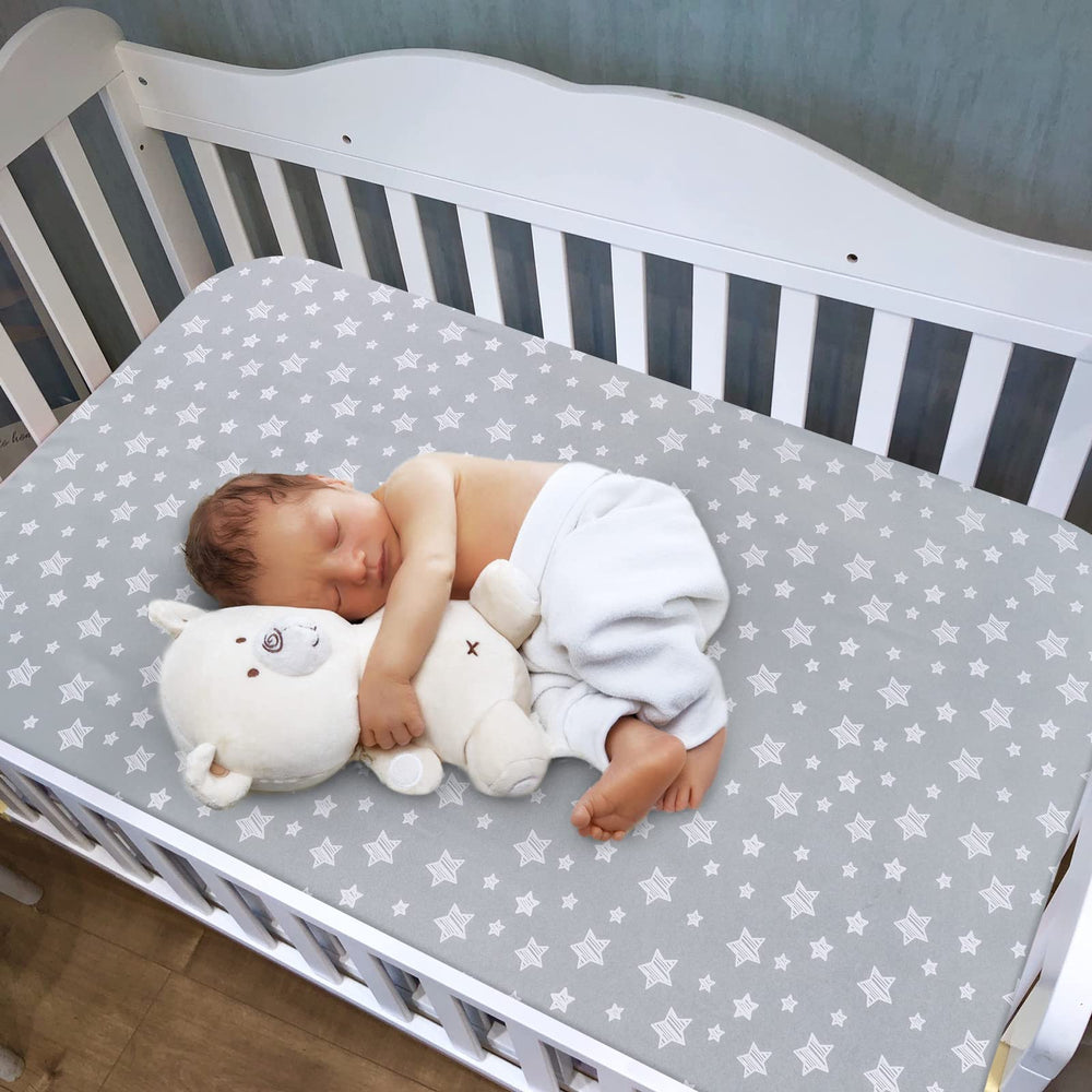 Moonsea crib sheets snug-fit elastic edge demonstrates secure fit on standard crib mattress.
