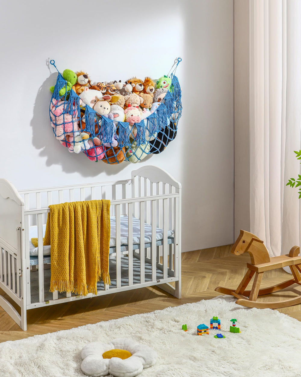 MORCCO blue XL plushie net beside bed for quick toy access.