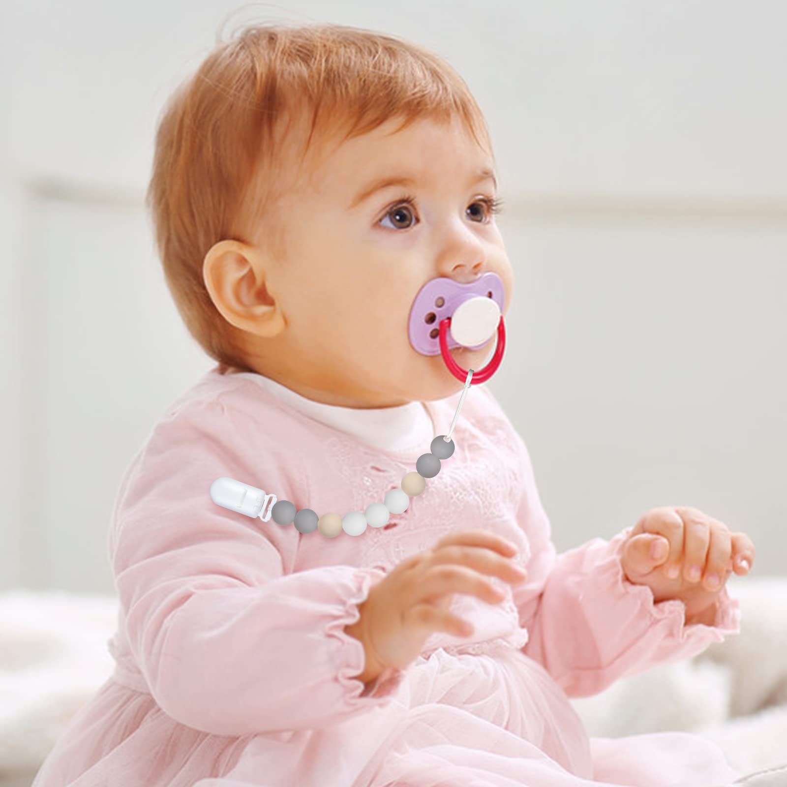 MORIBOX pacifier clip closeup shows secure clip and easy-to-attach design for parents.