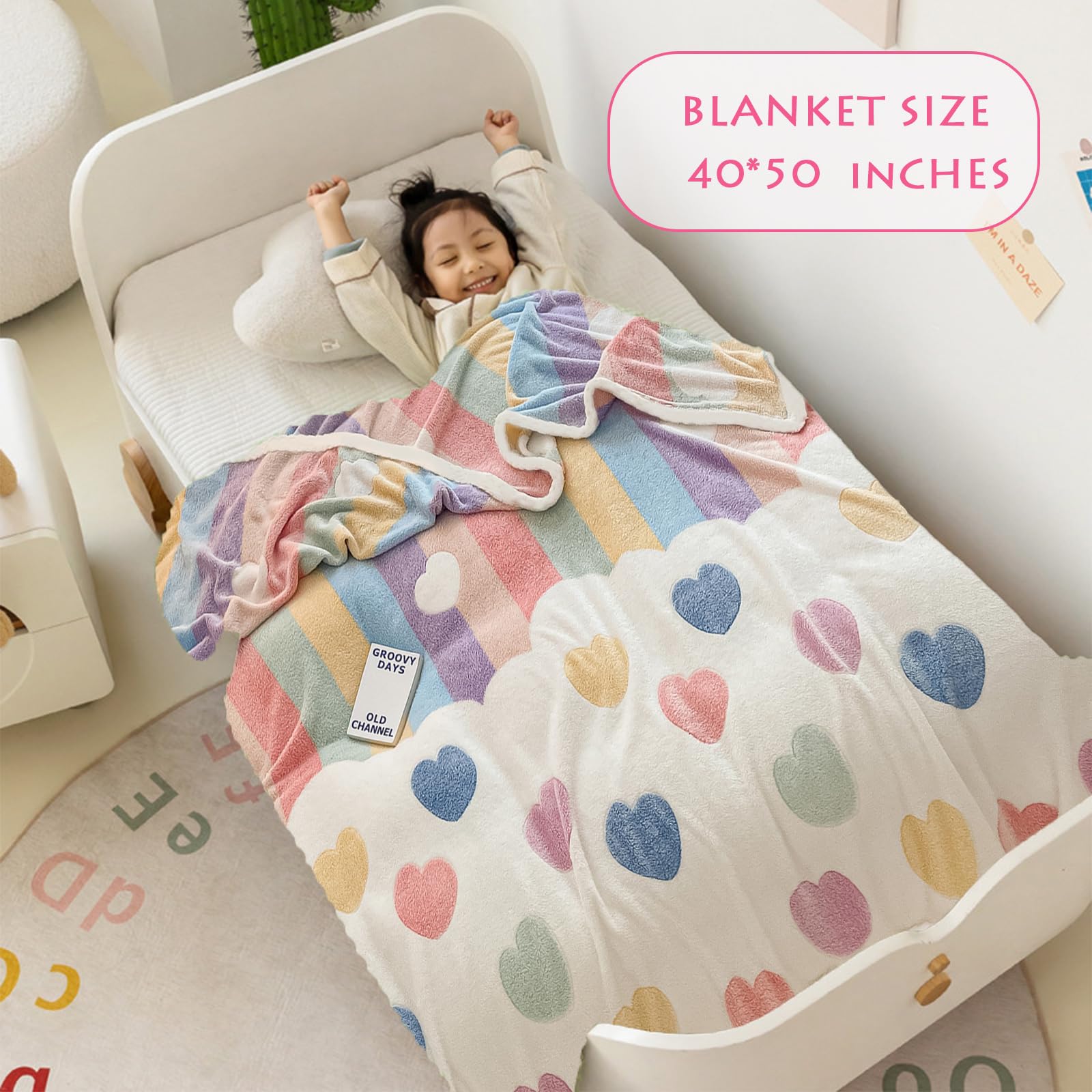 MorroMorn Rainbow Love blanket folded on a bed for versatile nursery decor.