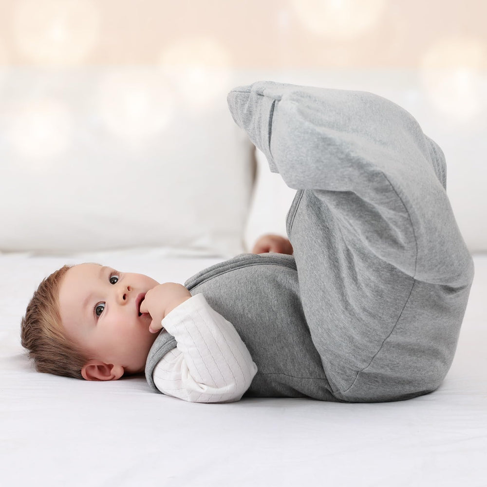 Mosebears Sleep Sack baby sleeping in grey sleep sack for secure warmth.