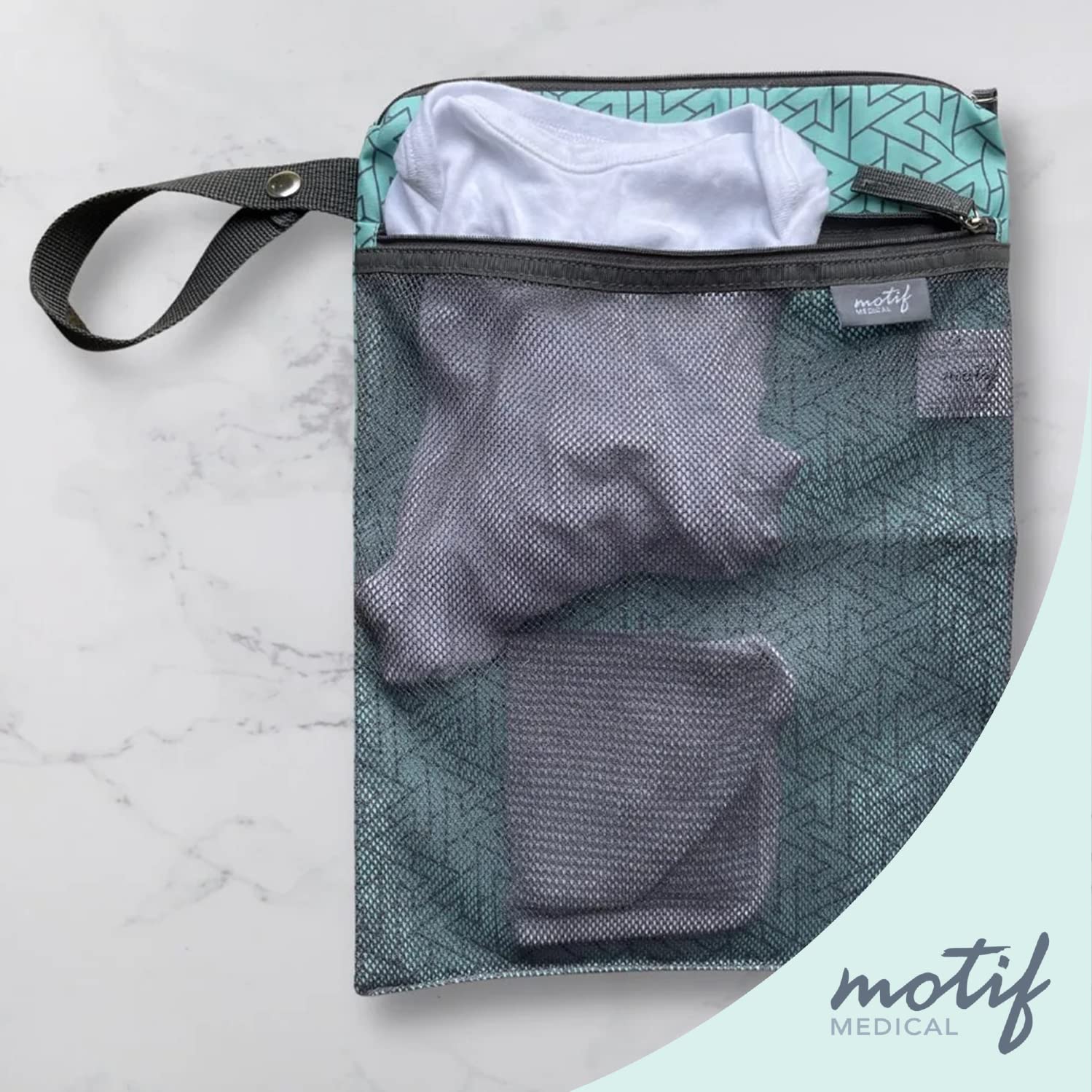 Motif Medical aqua wet dry bag shows a dry front pocket for diapers or milk bags.