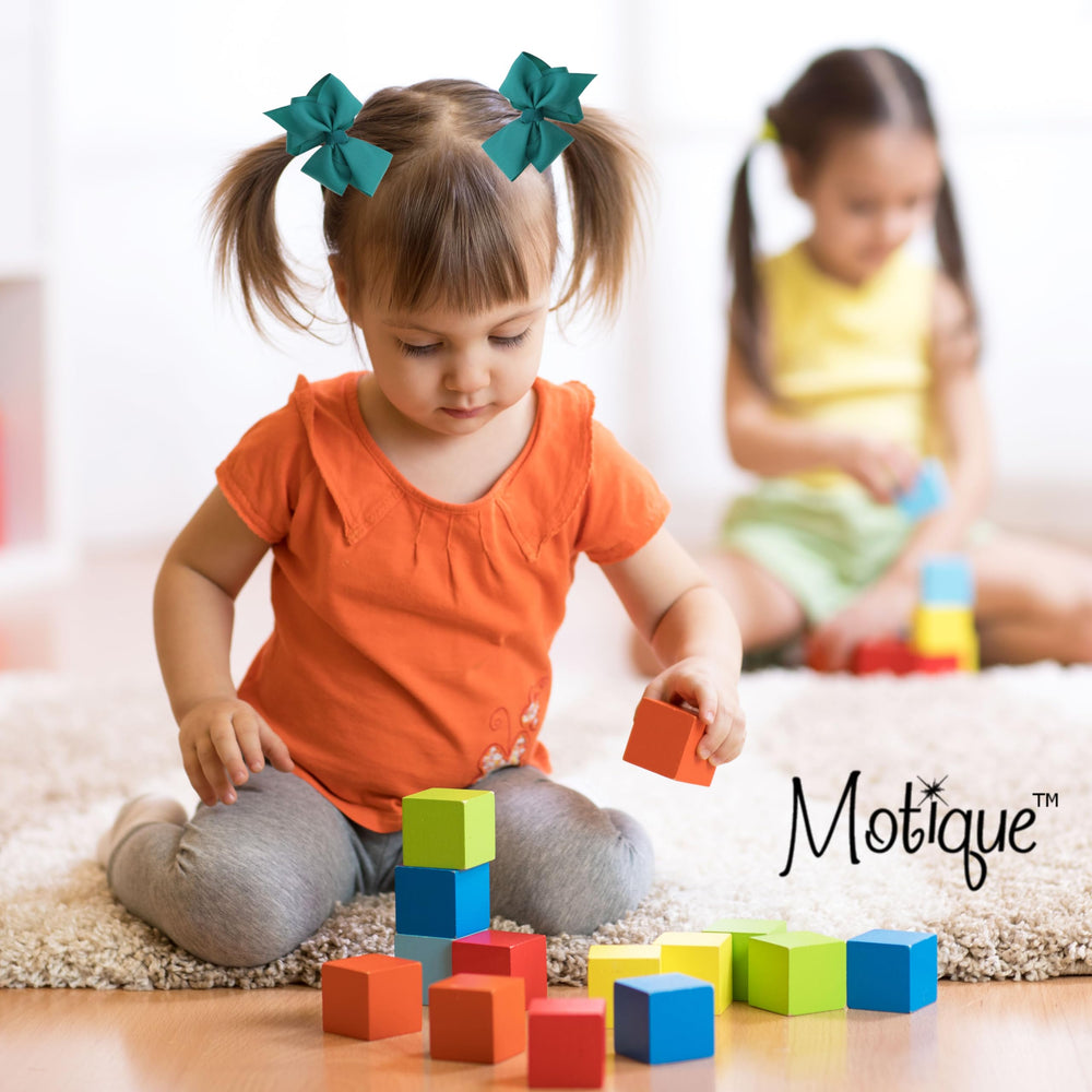Motique dark turquoise bow with an alligator clip keeps hair secure during activities.