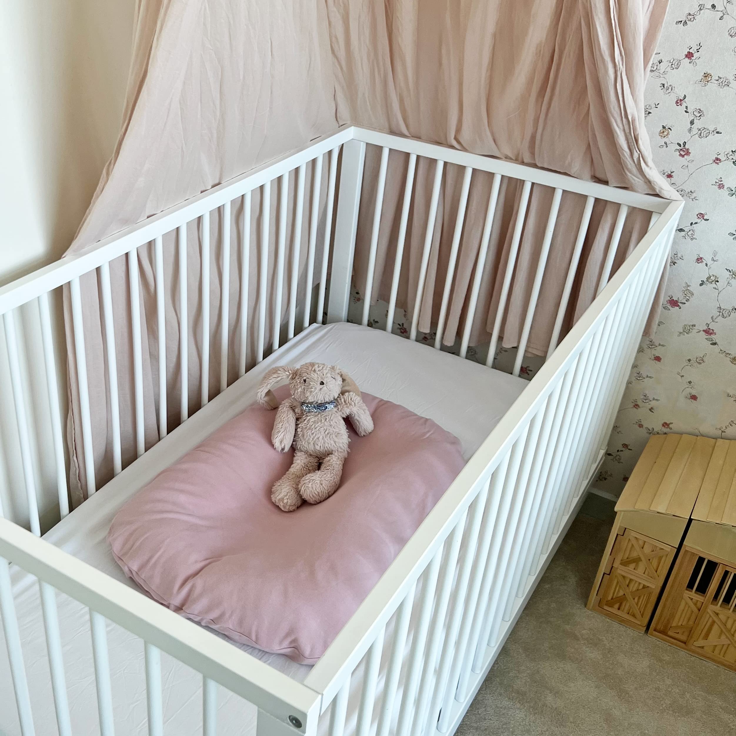 MOZAH newborn lounger cover brightens a nursery with soft color.