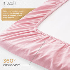 MOZAH organic muslin crib sheets on crib showing breathable sleep surface