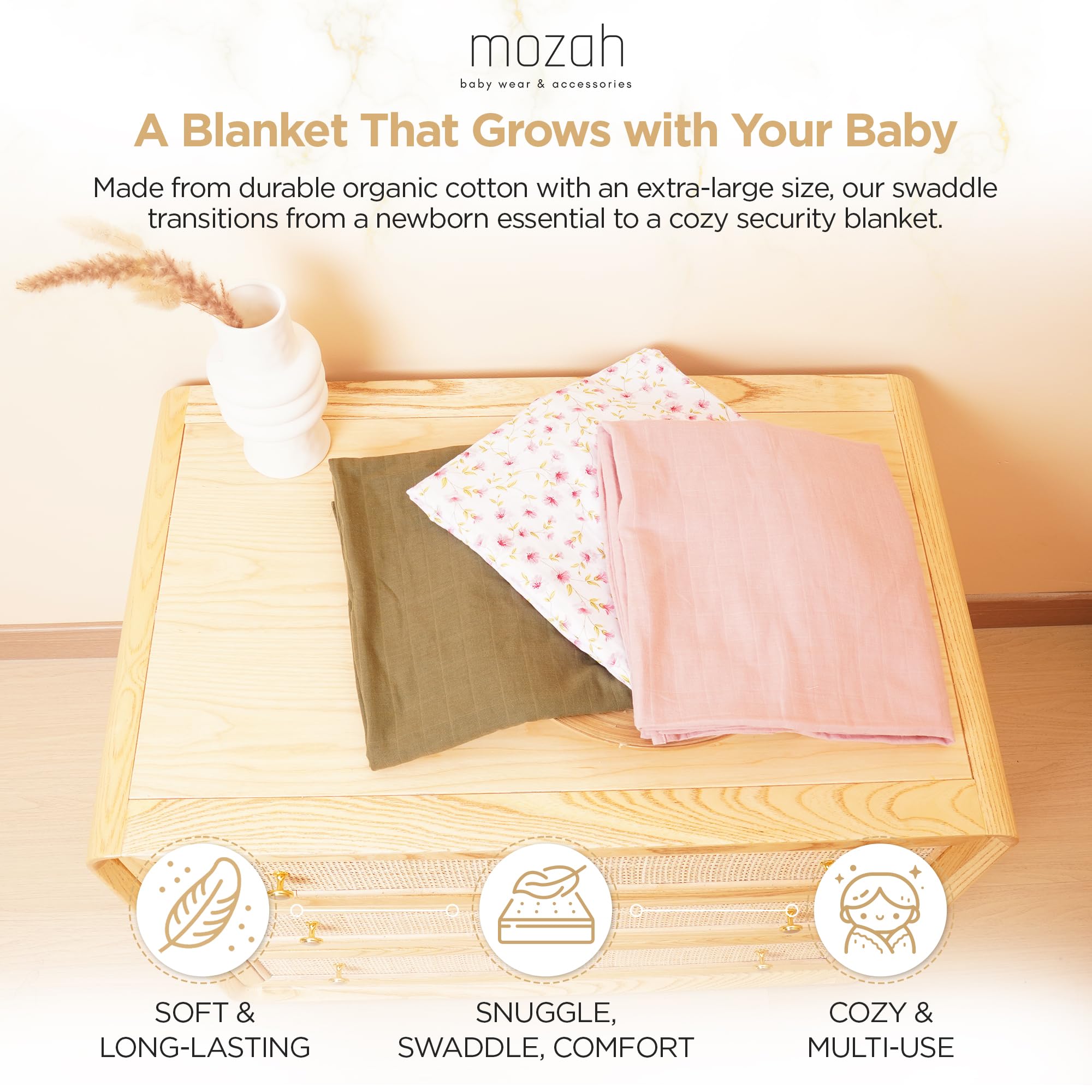 MOZAH swaddle pink leaves closeup: playful pattern with gentle wrap for nap time.