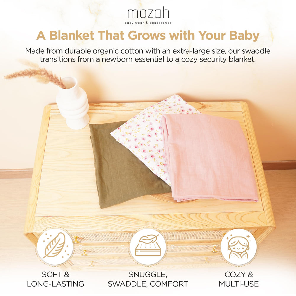 MOZAH swaddle pink leaves closeup: playful pattern with gentle wrap for nap time.