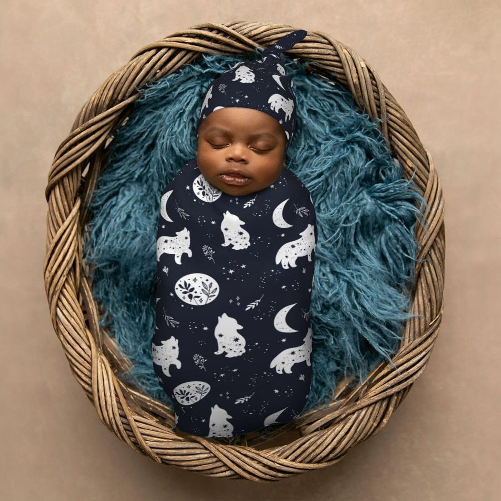 Muishi Boho Wolf newborn wardrobe setup with blanket and hat for easy outfit changes.