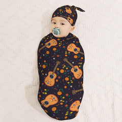 Muishi Guitar with Moon swaddle wrapped in blanket demonstrating cocoon security