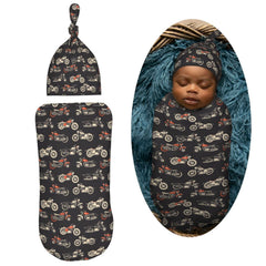 Muishi motorcycles-on-black-background swaddle blanket detail highlights elastic edge for secure wrapping.