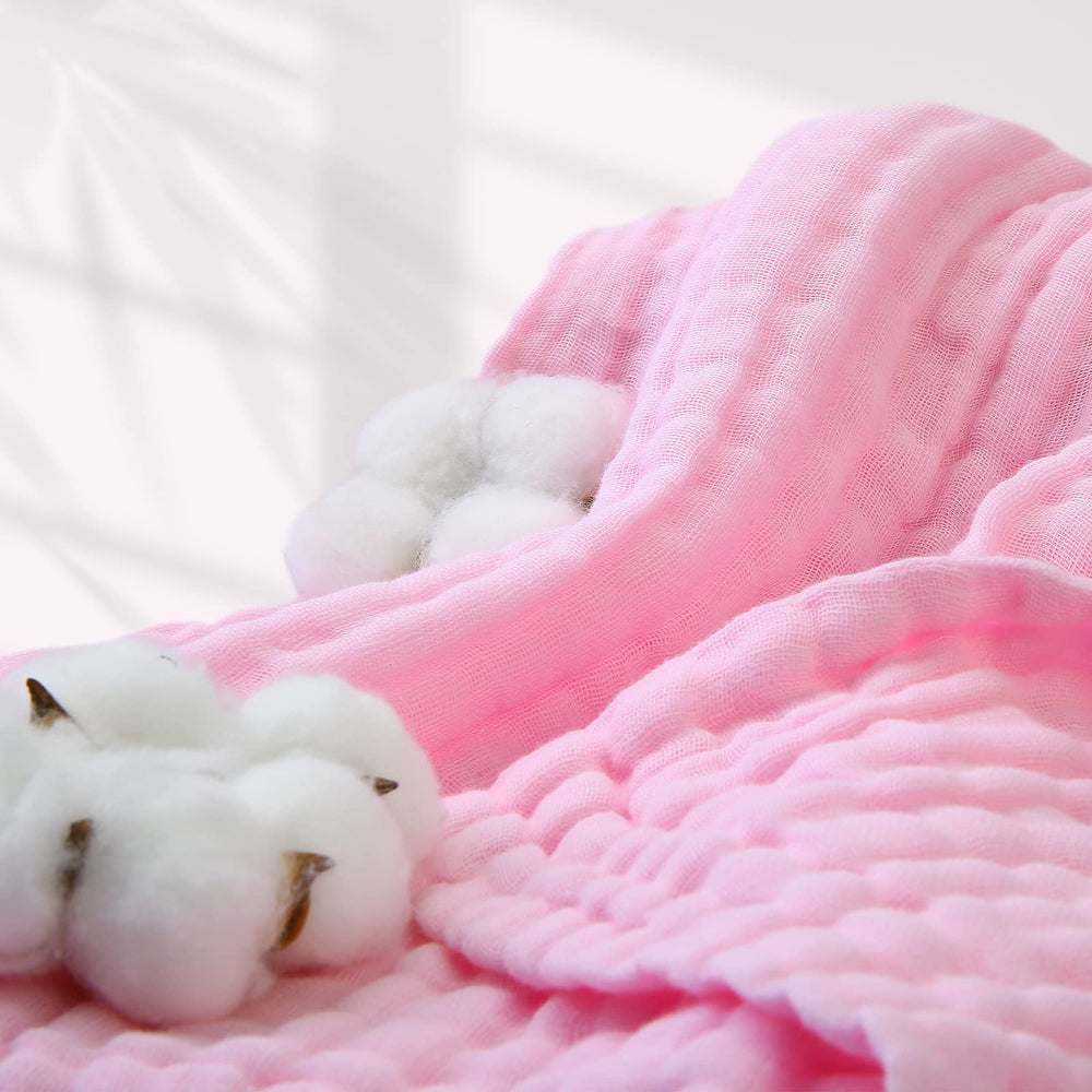 MUKIN swaddle blanket wrapped around sleeping baby demonstrating versatility.